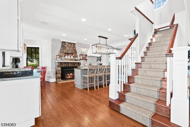 Chandelier, Dining room, Fireplace, Interior, Kitchen, Pendant Lights, Recessed Lighting, Stone Walls, Wood Texture Flooring
