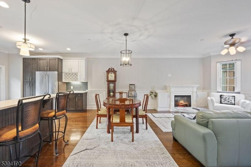 Dining room, Fireplace, Interior, Kitchen, Living room, Pendant Lights, Recessed Lighting, Stainless Steel Appliances, Wood Texture Flooring