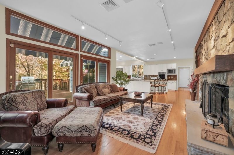 Fireplace, Interior, Kitchen, Living room, Recessed Lighting, Stone Walls, Wood Texture Flooring