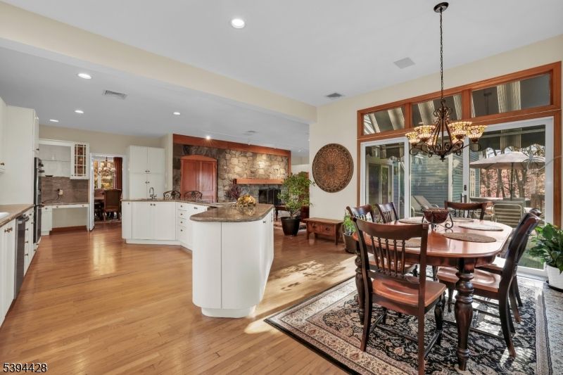Chandelier, Dining room, Fireplace, Interior, Kitchen, Recessed Lighting, Stone Walls, Wood Texture Flooring
