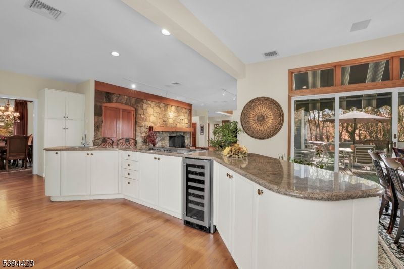 Dining room, Fireplace, Interior, Kitchen, Recessed Lighting, Stone Walls, Wood Texture Flooring