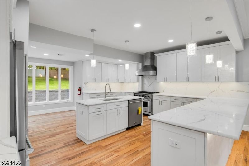 Interior, Kitchen, Marble Walls, Pendant Lights, Recessed Lighting, Stainless Steel Appliances, Wood Texture Flooring