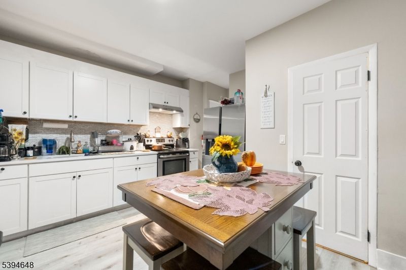 Dining room, Interior, Kitchen, Recessed Lighting, Stainless Steel Appliances, Wood Texture Flooring