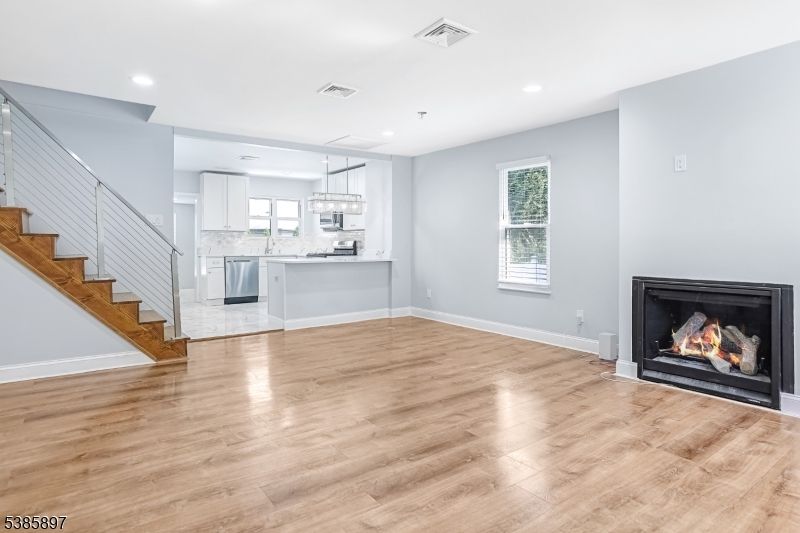 Chandelier, Empty room, Fireplace, Interior, Kitchen, Pendant Lights, Recessed Lighting, Wood Texture Flooring