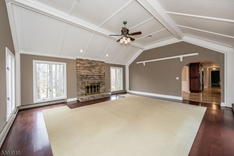Empty room, Fireplace, Interior, Recessed Lighting, Stone Walls, Wood Texture Flooring