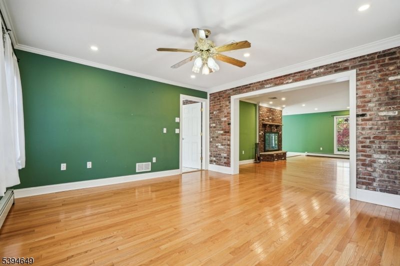 Empty room, Fireplace, Interior, Recessed Lighting, Stone Walls, Wood Texture Flooring