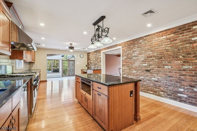 Interior, Kitchen, Pendant Lights, Recessed Lighting, Stainless Steel Appliances, Stone Walls, Wood Texture Flooring