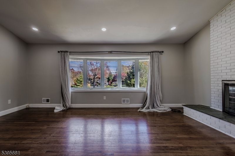 Empty room, Fireplace, Interior, Recessed Lighting, Stone Walls, Wood Texture Flooring