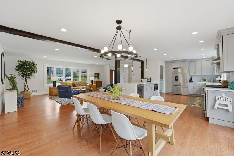 Chandelier, Dining room, Interior, Kitchen, Living room, Pendant Lights, Recessed Lighting, Stainless Steel Appliances, Wood Texture Flooring