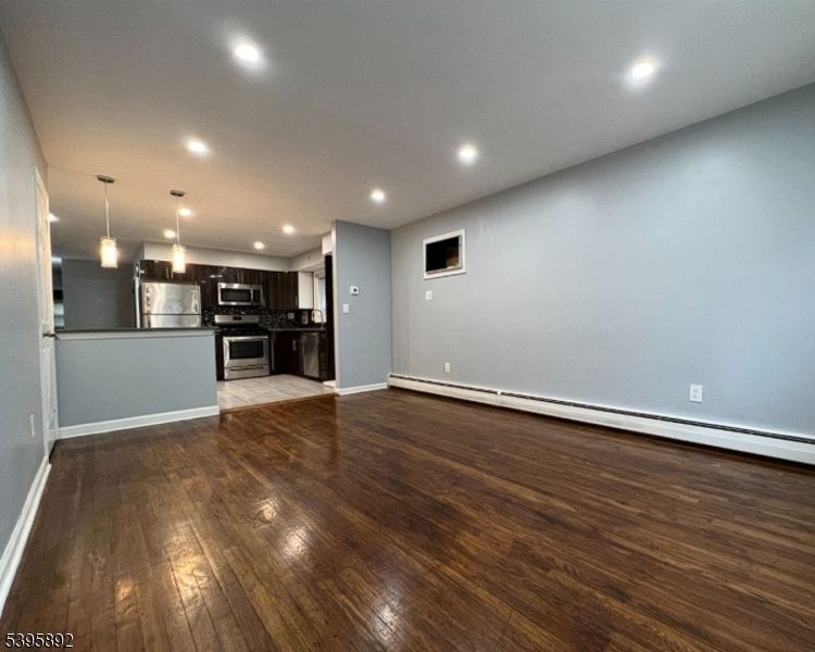 Empty room, Interior, Kitchen, Pendant Lights, Recessed Lighting, Stainless Steel Appliances, Wood Texture Flooring