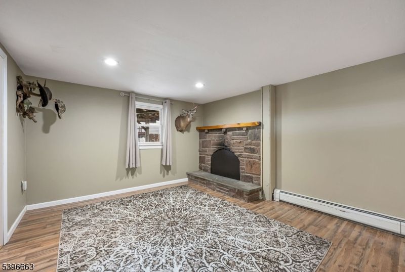 Empty room, Fireplace, Interior, Recessed Lighting, Stone Walls, Wood Texture Flooring