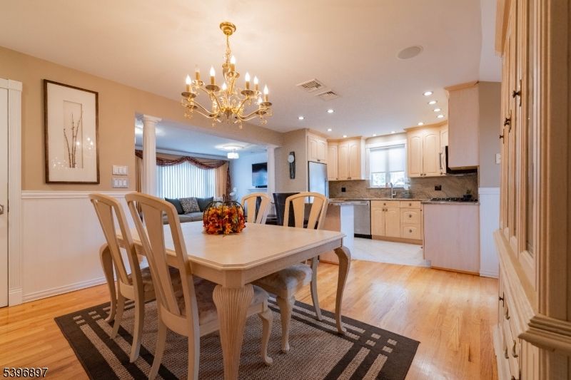 Chandelier, Dining room, Interior, Kitchen, Recessed Lighting, Stainless Steel Appliances, Wood Texture Flooring