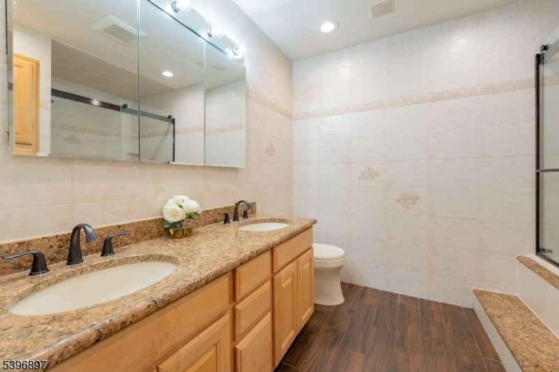 Bathroom, Dual Sink Vanities, Glass Shower, Interior, Recessed Lighting, Wood Texture Flooring