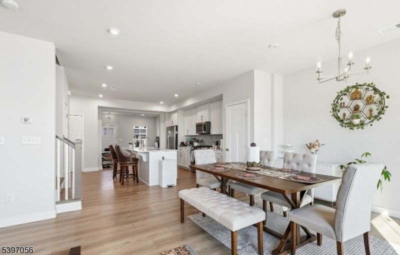 Chandelier, Dining room, Interior, Kitchen, Pendant Lights, Recessed Lighting, Stainless Steel Appliances, Wood Texture Flooring