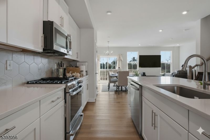 Chandelier, Dining room, Interior, Kitchen, Pendant Lights, Recessed Lighting, Stainless Steel Appliances, Wood Texture Flooring