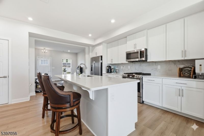 Interior, Kitchen, Marble Walls, Recessed Lighting, Stainless Steel Appliances, Wood Texture Flooring