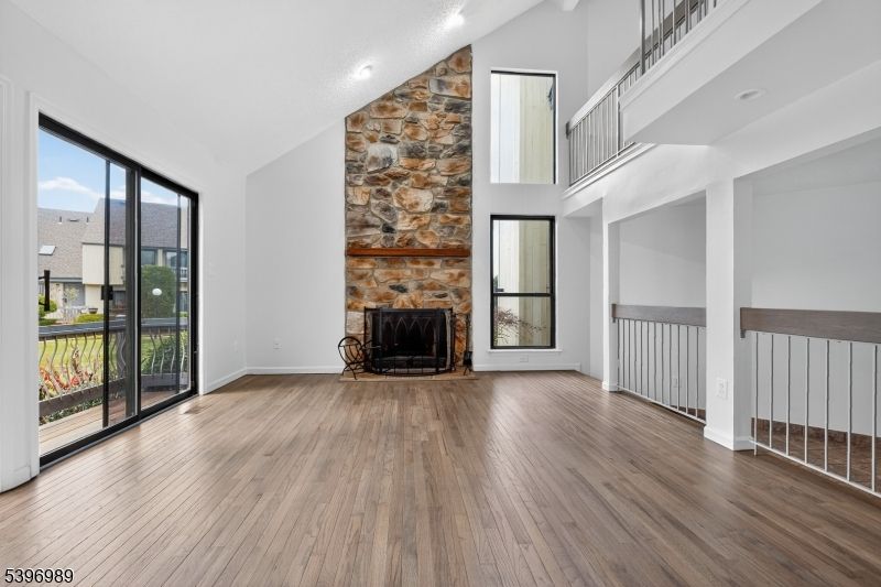 Empty room, Fireplace, Interior, Recessed Lighting, Stone Walls, Wood Texture Flooring