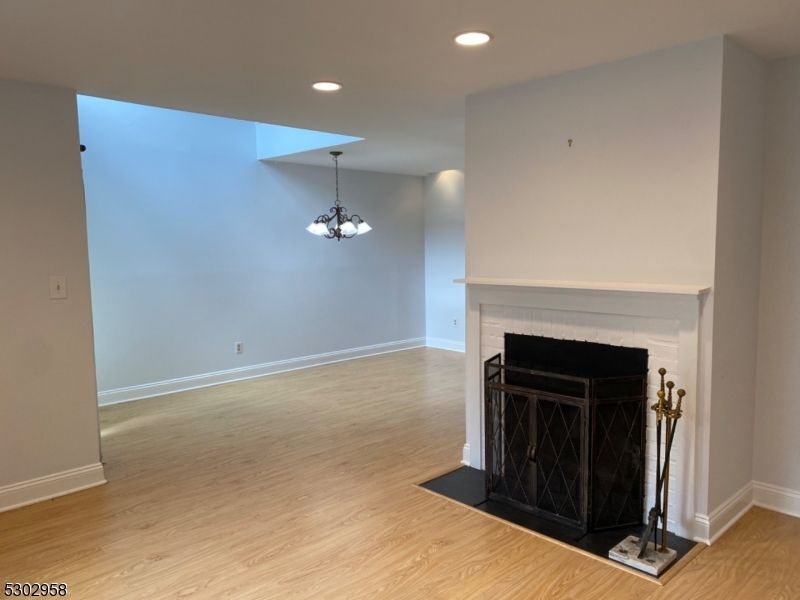 Chandelier, Empty room, Fireplace, Interior, Recessed Lighting, Wood Texture Flooring