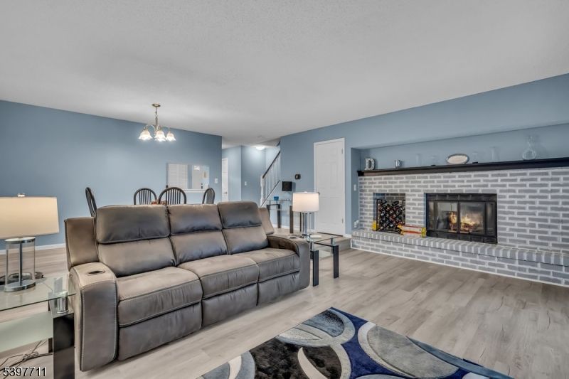 Chandelier, Dining room, Fireplace, Interior, Living room, Pendant Lights, Stone Walls, Wood Texture Flooring
