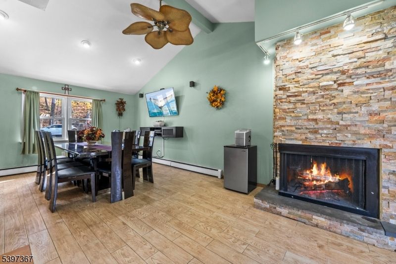 Dining room, Fireplace, Interior, Recessed Lighting, Stone Walls, Wood Texture Flooring