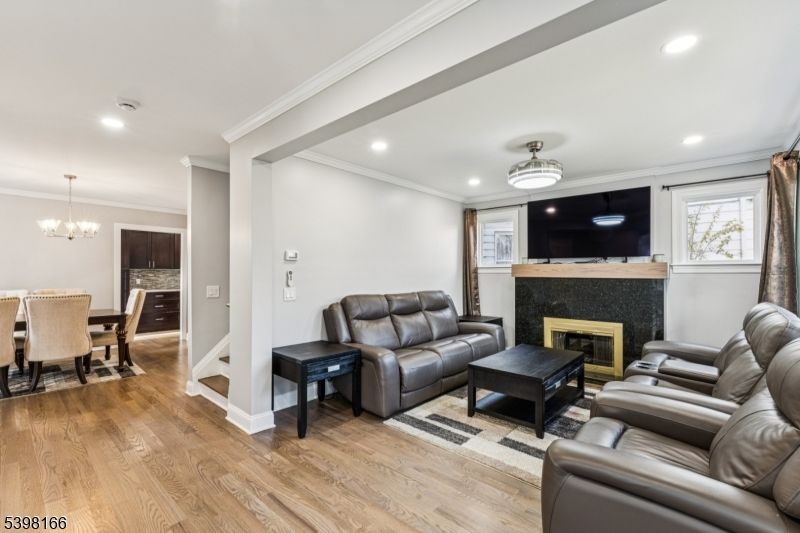 Chandelier, Dining room, Fireplace, Interior, Living room, Recessed Lighting, Wood Texture Flooring