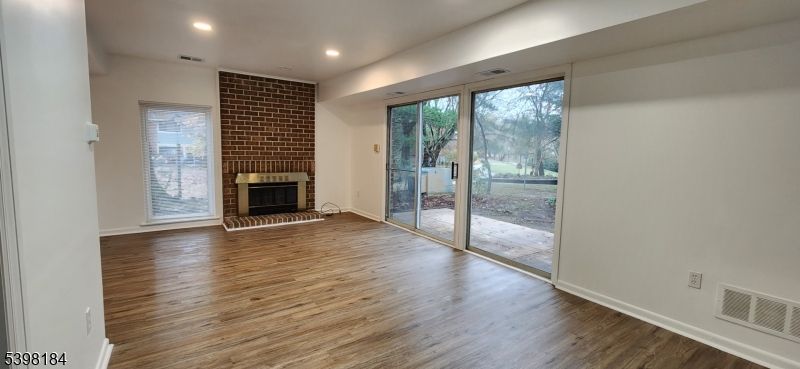 Empty room, Fireplace, Interior, Recessed Lighting, Stone Walls, Wood Texture Flooring