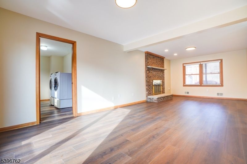 Empty room, Fireplace, Interior, Recessed Lighting, Stone Walls, Washer, Wood Texture Flooring