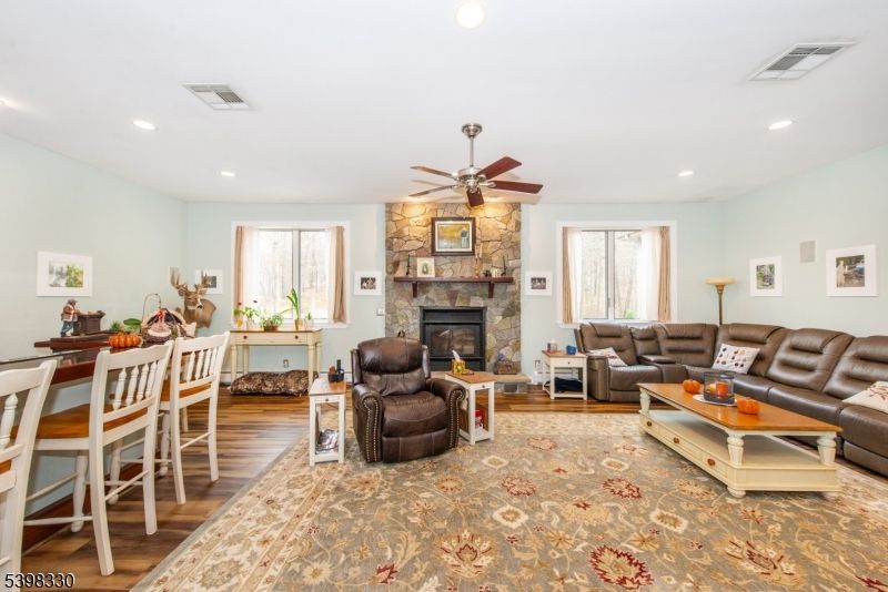 Dining room, Fireplace, Interior, Living room, Recessed Lighting, Stone Walls, Wood Texture Flooring