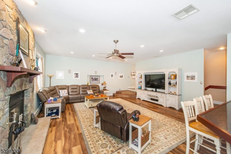 Fireplace, Interior, Living room, Recessed Lighting, Stone Walls, Wood Texture Flooring