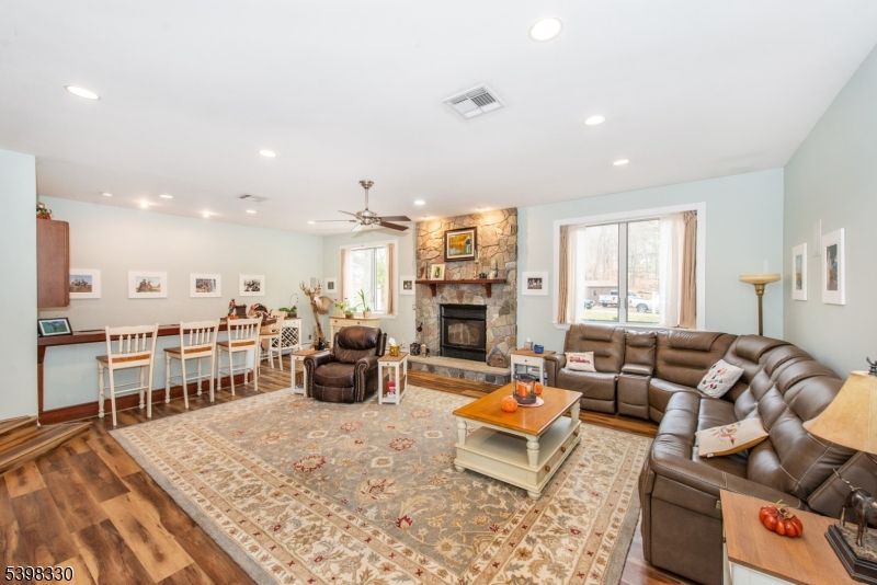 Dining room, Fireplace, Interior, Living room, Recessed Lighting, Stone Walls, Wood Texture Flooring