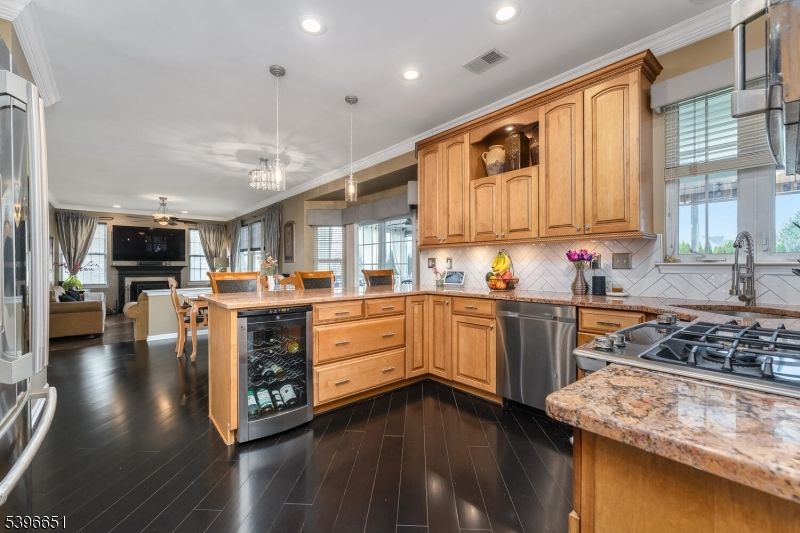 Dining room, Fireplace, Interior, Kitchen, Pendant Lights, Recessed Lighting, Stainless Steel Appliances, Wood Texture Flooring