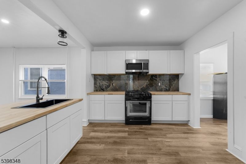 Interior, Kitchen, Marble Walls, Recessed Lighting, Stainless Steel Appliances, Wood Texture Flooring
