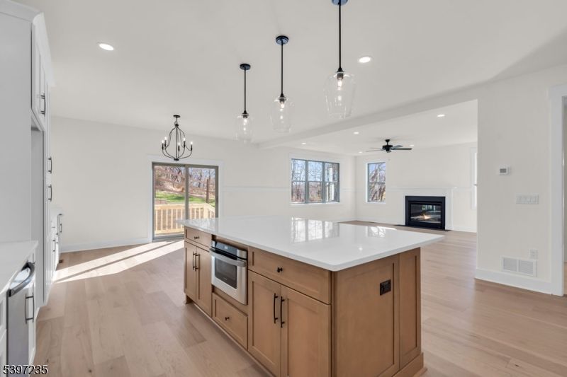 Empty room, Fireplace, Interior, Kitchen, Pendant Lights, Recessed Lighting, Wood Texture Flooring