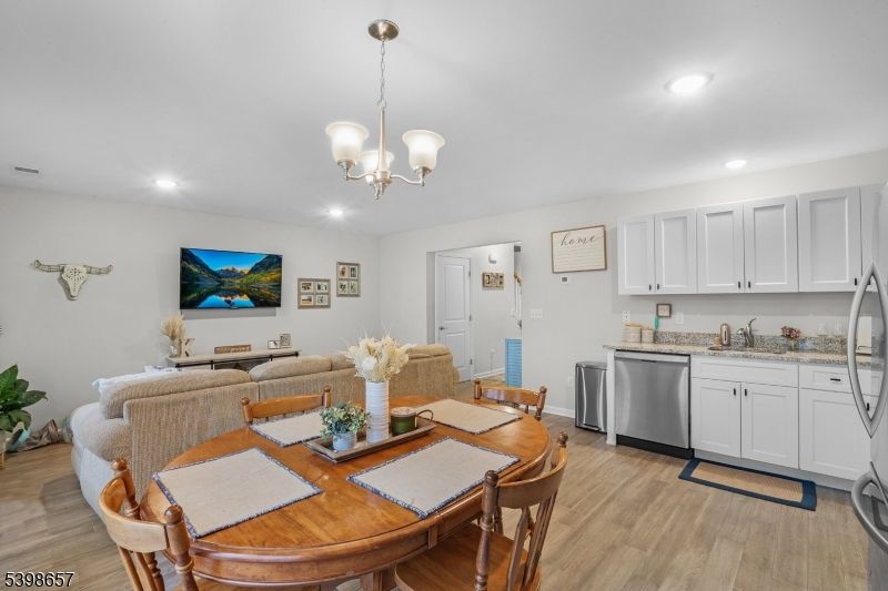 Chandelier, Dining room, Interior, Kitchen, Living room, Recessed Lighting, Stainless Steel Appliances, Wood Texture Flooring