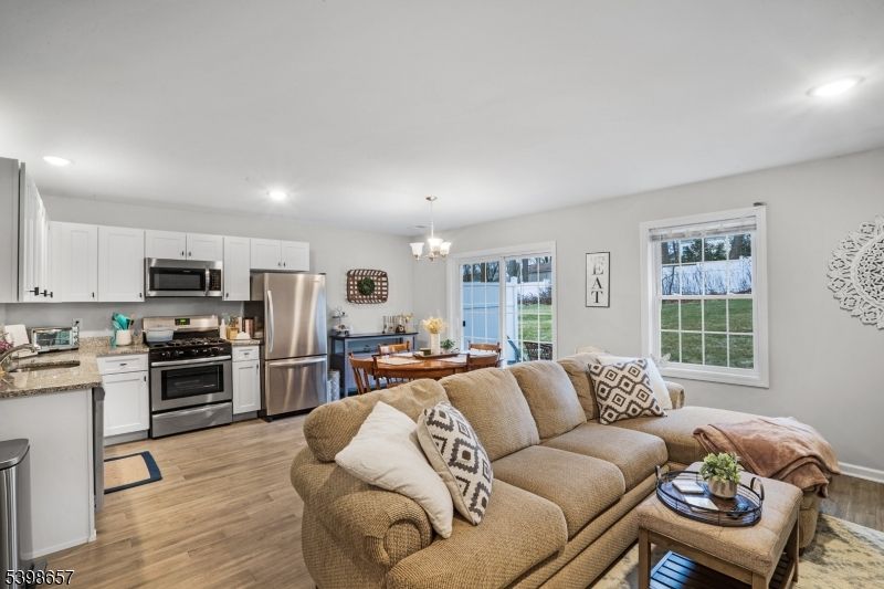 Chandelier, Dining room, Interior, Kitchen, Living room, Recessed Lighting, Stainless Steel Appliances, Wood Texture Flooring