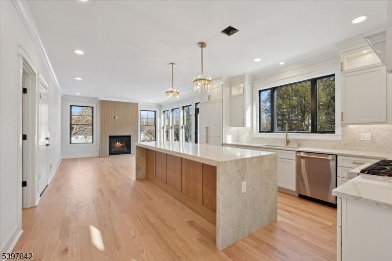 Chandelier, Fireplace, Interior, Kitchen, Recessed Lighting, Stainless Steel Appliances, Wood Texture Flooring