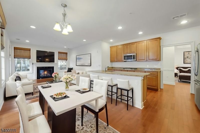 Chandelier, Dining room, Fireplace, Interior, Kitchen, Living room, Pendant Lights, Recessed Lighting, Wood Texture Flooring