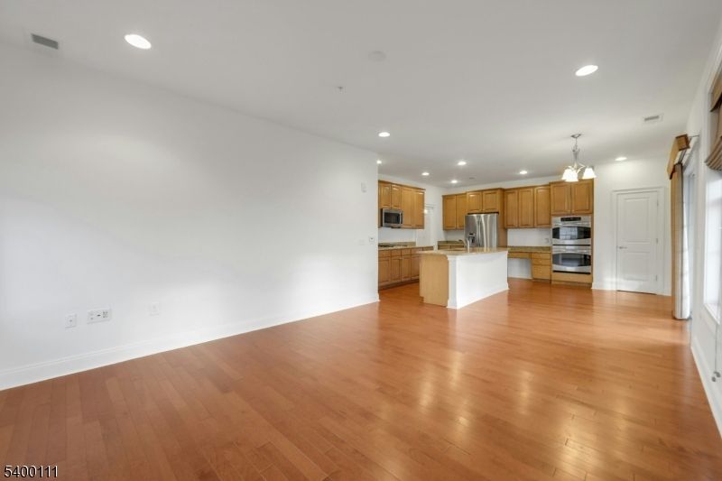 Chandelier, Empty room, Interior, Kitchen, Recessed Lighting, Stainless Steel Appliances, Wood Texture Flooring