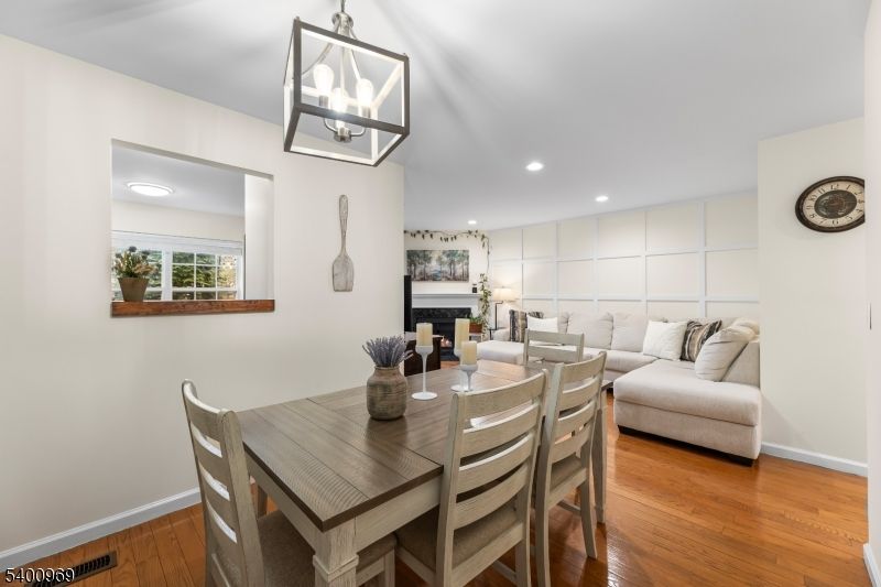 Dining room, Fireplace, Interior, Living room, Pendant Lights, Recessed Lighting, Wood Texture Flooring