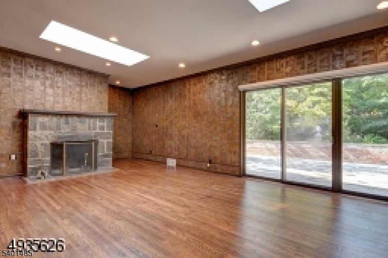 Empty room, Fireplace, Interior, Recessed Lighting, Stone Walls, Wood Texture Flooring, Wooden Walls