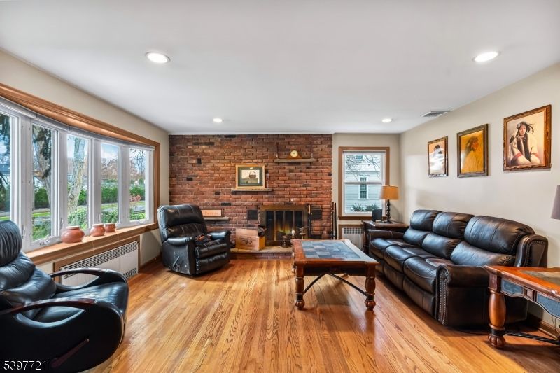 Fireplace, Interior, Living room, Recessed Lighting, Stone Walls, Wood Texture Flooring