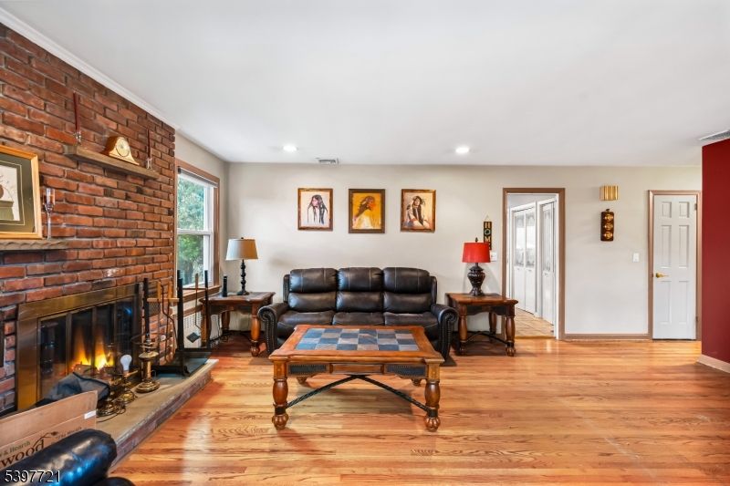 Fireplace, Interior, Living room, Recessed Lighting, Stone Walls, Wood Texture Flooring