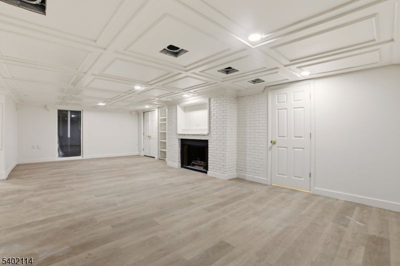 Empty room, Fireplace, Interior, Recessed Lighting, Stone Walls, Wood Texture Flooring