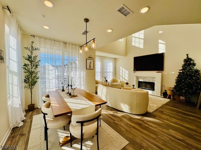 Dining room, Fireplace, Interior, Living room, Pendant Lights, Recessed Lighting, Wood Texture Flooring