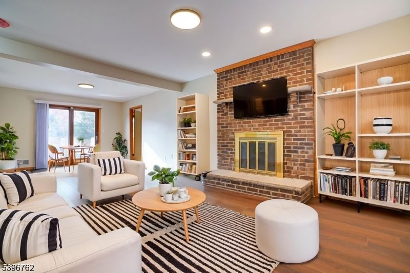 Dining room, Fireplace, Interior, Living room, Recessed Lighting, Stone Walls, Wood Texture Flooring