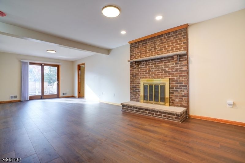 Empty room, Fireplace, Interior, Recessed Lighting, Stone Walls, Wood Texture Flooring