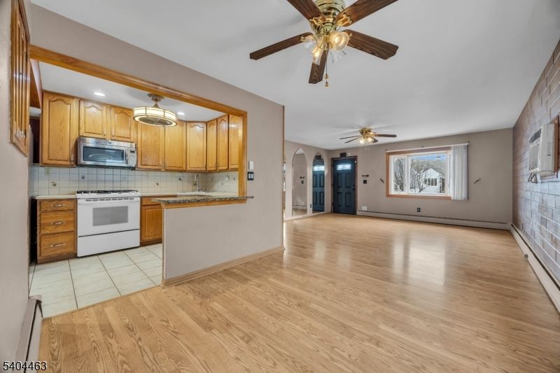 Empty room, Interior, Kitchen, Recessed Lighting, Tile Countertops, Wood Texture Flooring