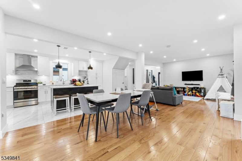 Dining room, Fireplace, Interior, Kitchen, Living room, Pendant Lights, Recessed Lighting, Stainless Steel Appliances, Wood Texture Flooring