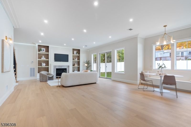 Dining room, Fireplace, Interior, Living room, Pendant Lights, Recessed Lighting, Wood Texture Flooring