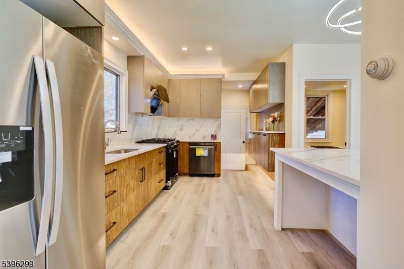 Interior, Kitchen, Marble Walls, Recessed Lighting, Stainless Steel Appliances, Wood Texture Flooring